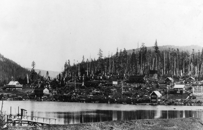 Black and White photo of a camp adjacent to the dam