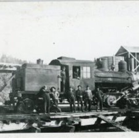 Black and White Photo of men on a Rail car